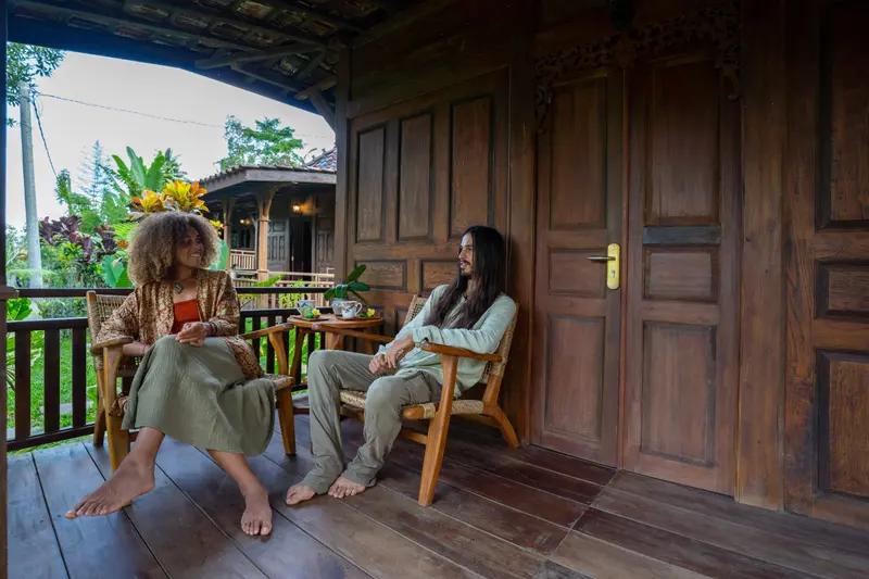 Two guests relaxing with tea on the Joglo terrace